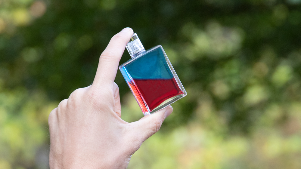 New Equilibrium bottle being held in nature - Pan B117